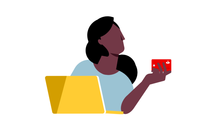 mujer frente a una laptop sosteniendo en su mano una tarjeta Santander