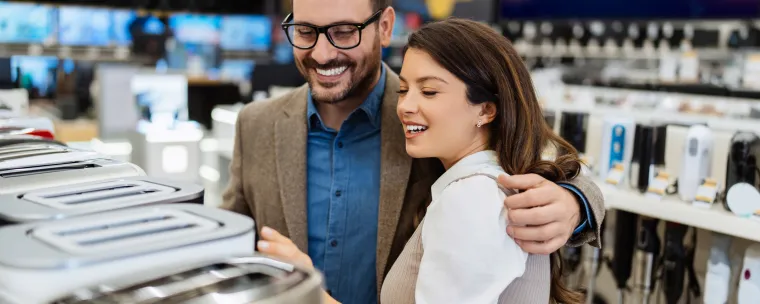 mujer y hombre abrazados comprando una tostadora